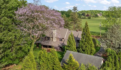 an aerial view of a house with a yard