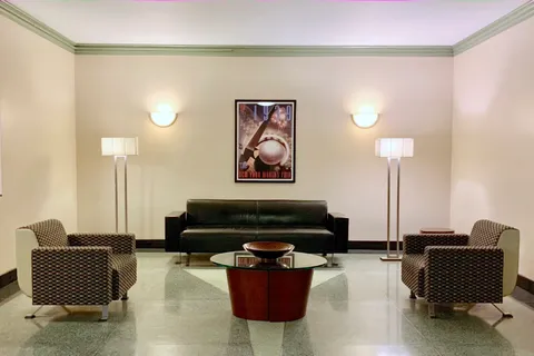 a living room with furniture and a lamp