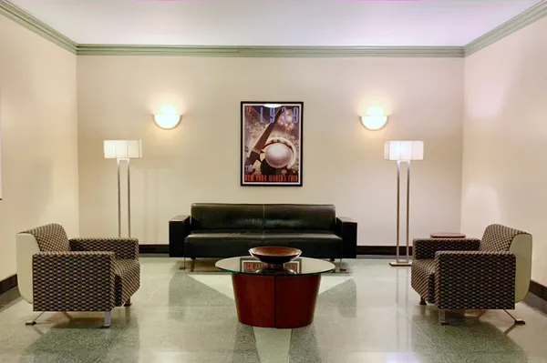 a living room with furniture and a lamp