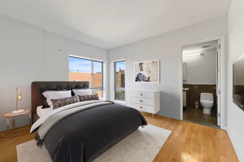 a bedroom with a large bed and a chandelier