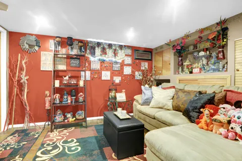 a living room with furniture and painting on the wall