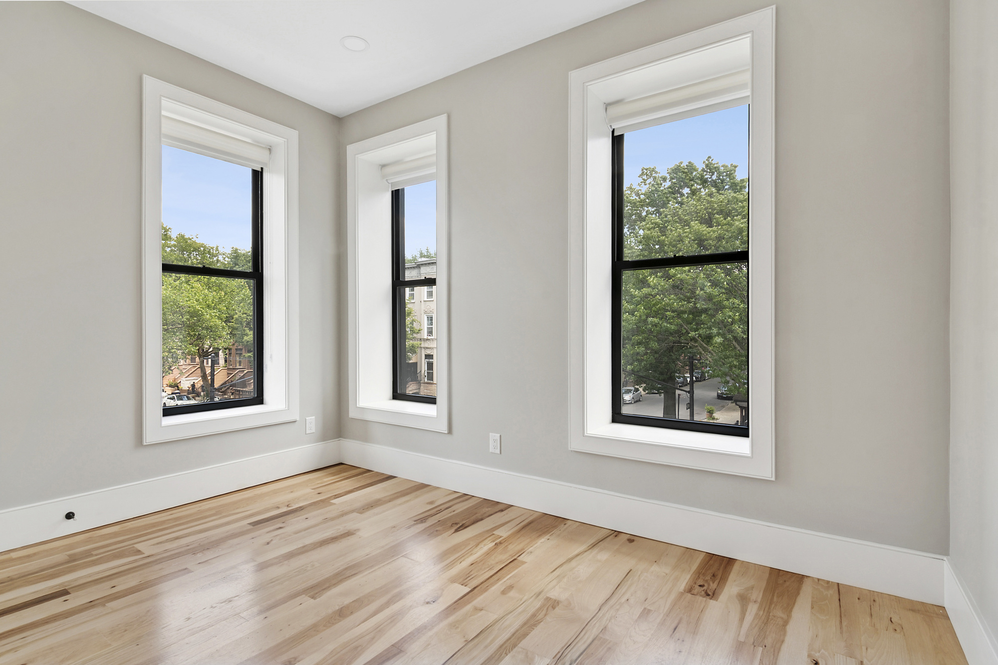 264 Stuyvesant Avenue, Unit 2 Brooklyn, NY 11221 - Photo 4 of 9 an empty room with wooden floor and windows