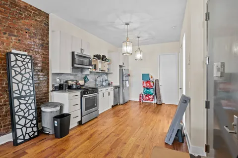 a living room with stainless steel appliances kitchen island granite countertop furniture and a kitchen view