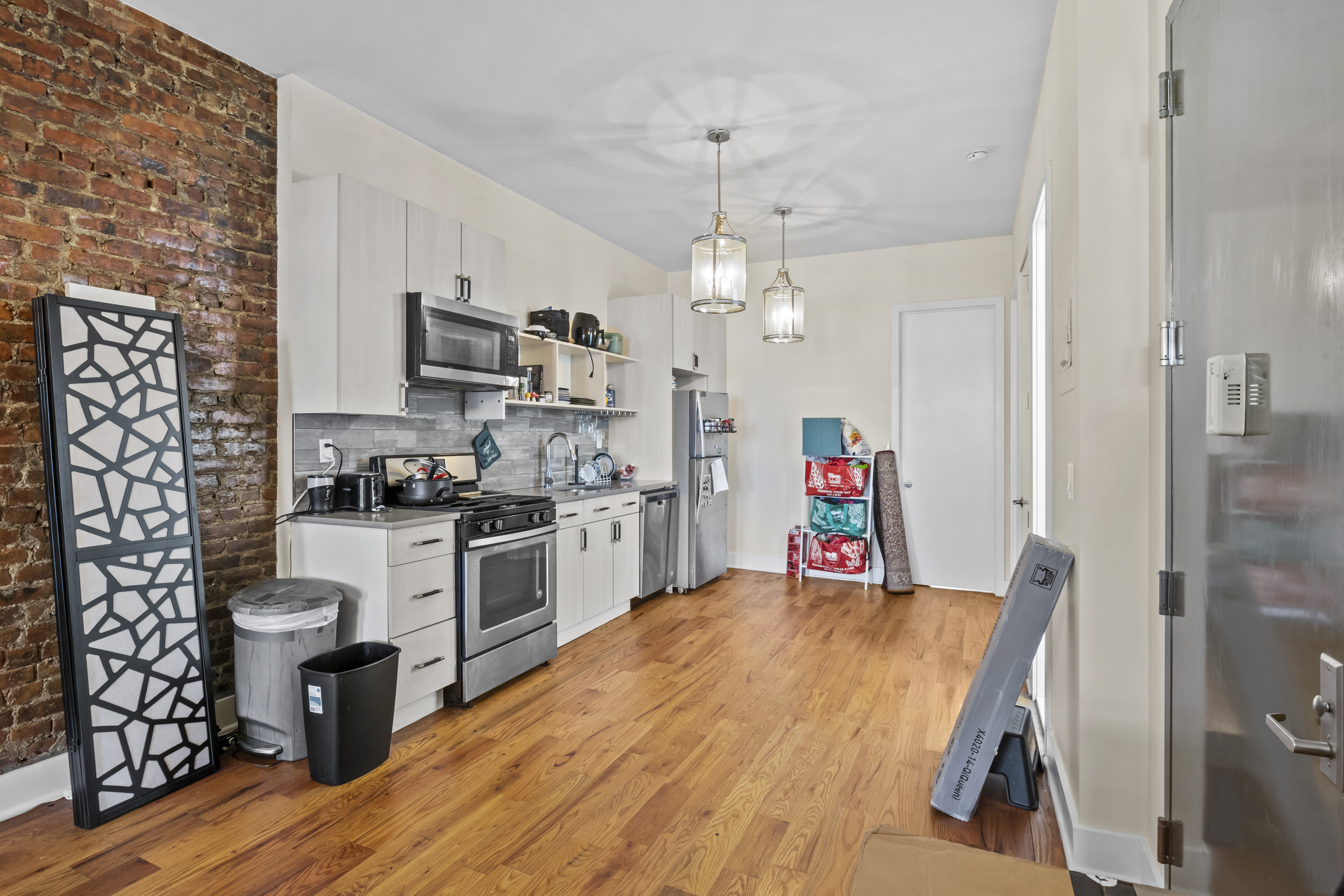 1273 Rogers Avenue, Unit MULTIFAM Brooklyn, NY 11226 - Photo 10 of 13 a living room with stainless steel appliances kitchen island granite countertop furniture and a kitchen view