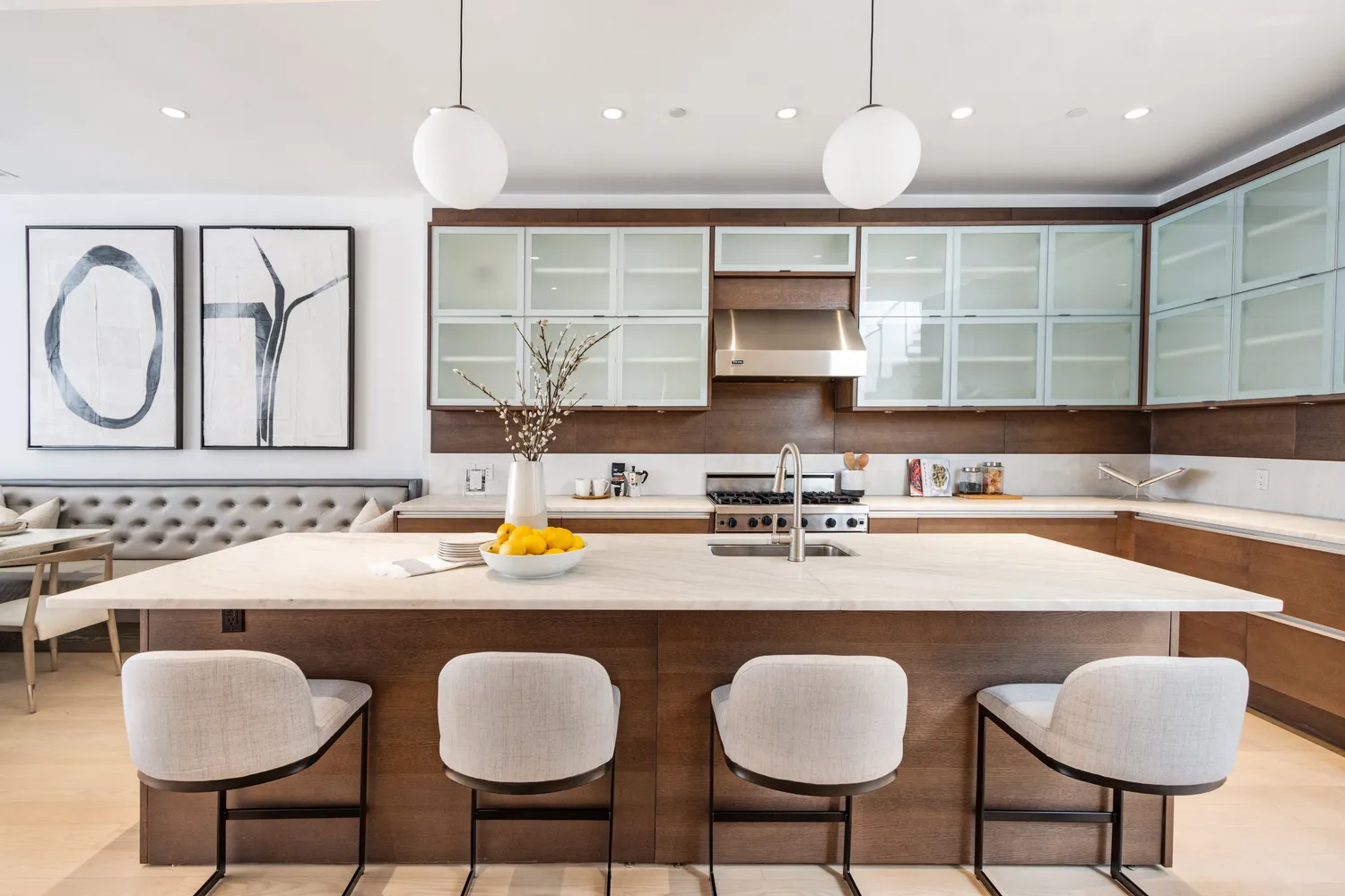 a kitchen with a dining table chairs and white cabinets