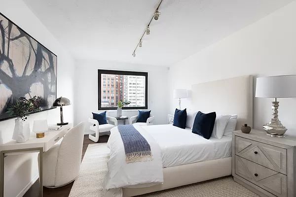 a bedroom with a large bed and a window