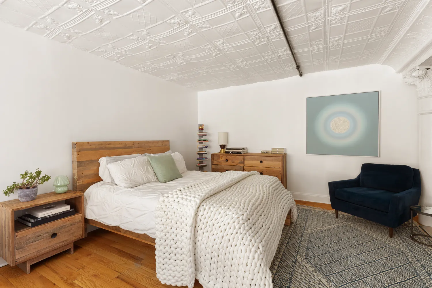 a bedroom with a bed and a potted plant