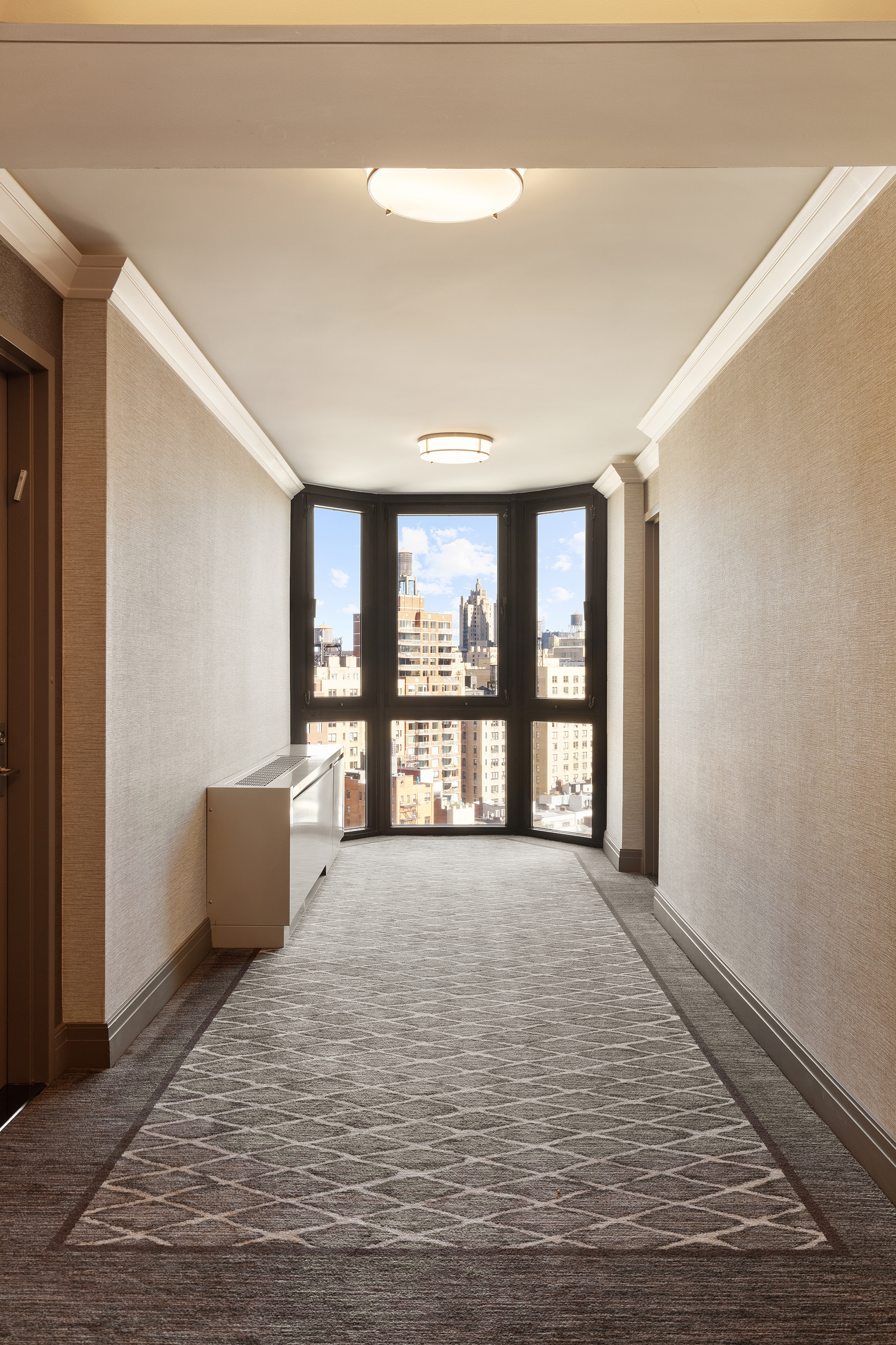 225 West 83rd Street, Unit 19A Manhattan, NY 10024 - Photo 9 of 15 a spacious bedroom with a large bed and a large window