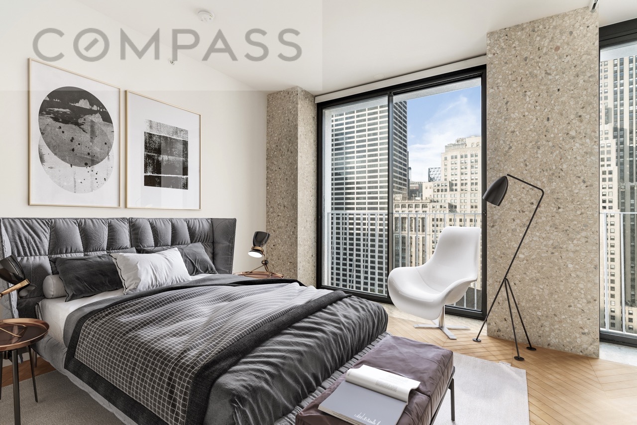 16 West 40th Street, Unit 21B Manhattan, NY 10018 - Photo 9 of 18 a bedroom with a bed and a chair