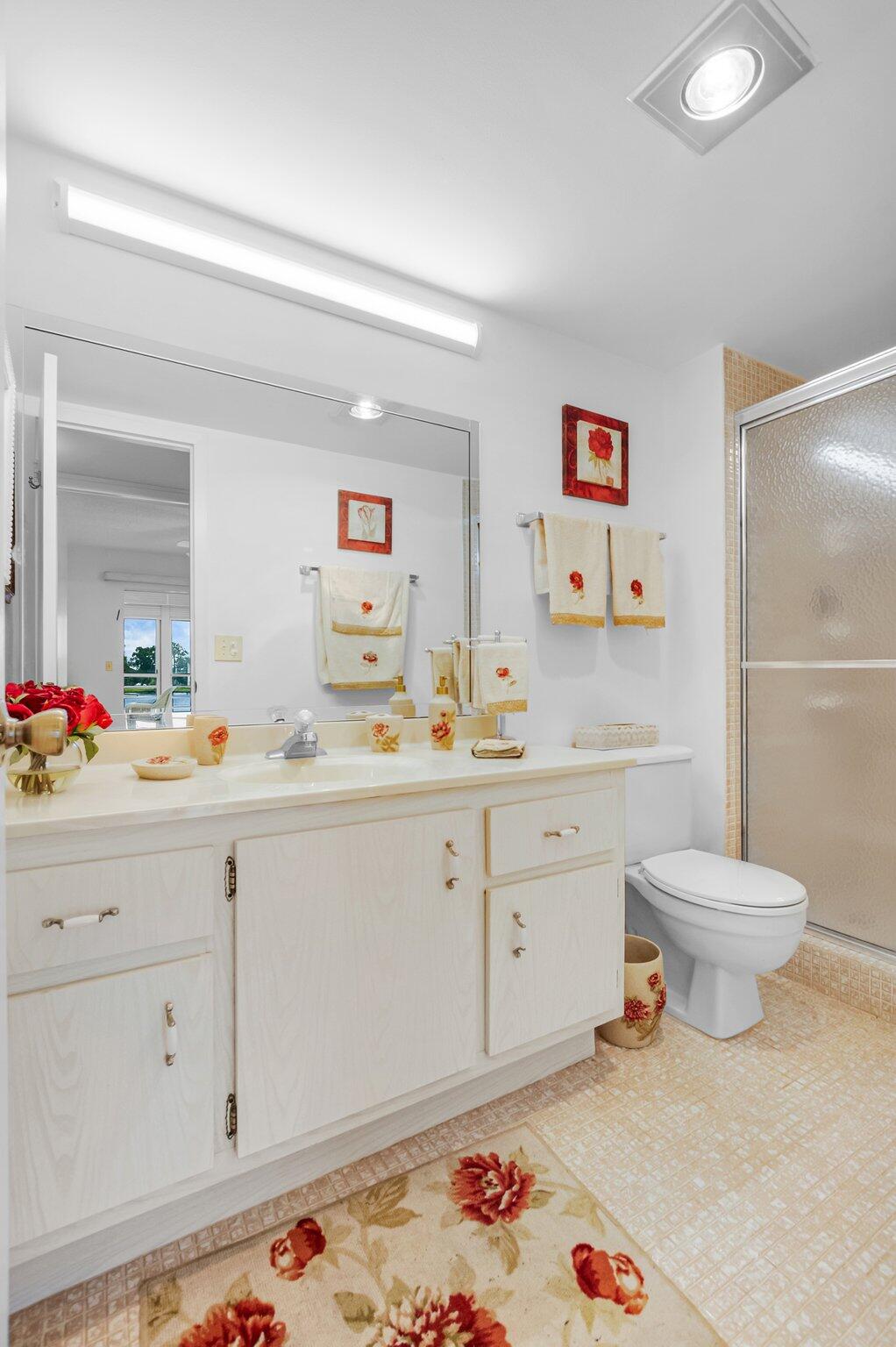 2035 Ainslie C Boca Raton, FL 33434 - Photo 9 of 17 a spacious bathroom with sink and mirror