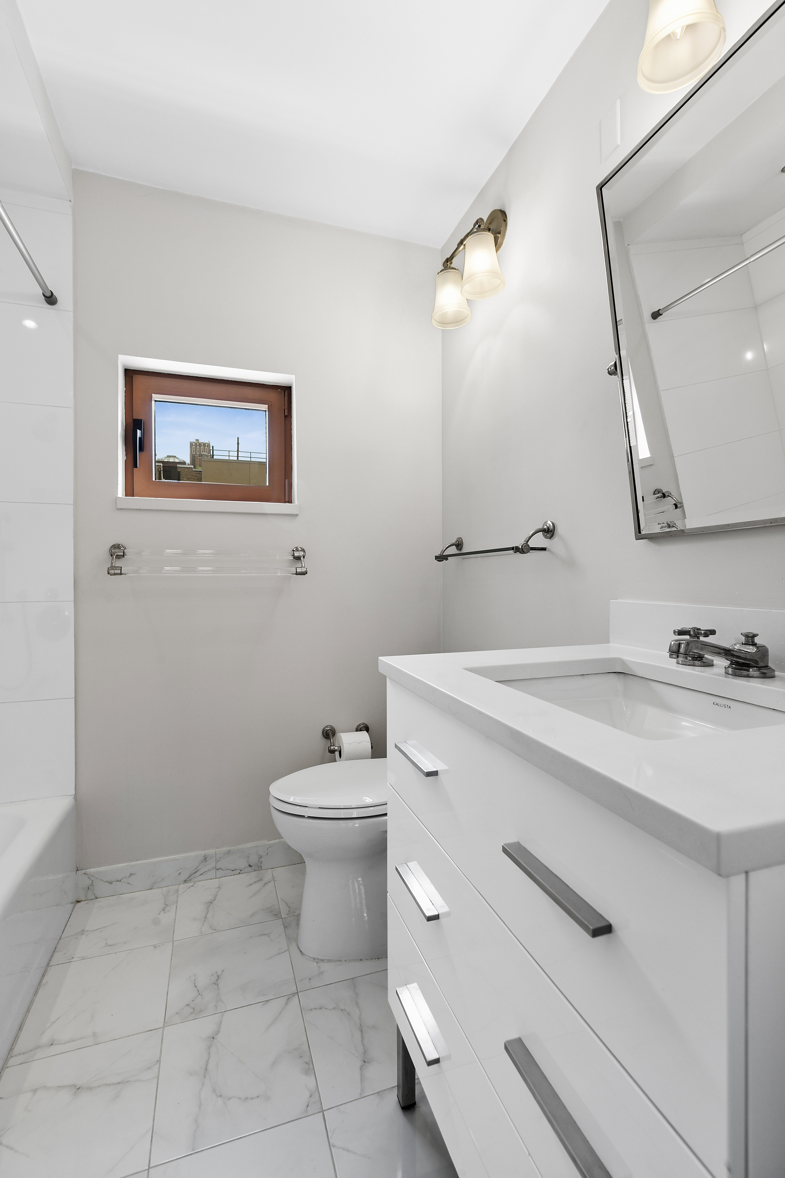 270 West 17th Street, Unit 4L Manhattan, NY 10011 - Photo 6 of 11 a bathroom with a sink mirror vanity and toilet