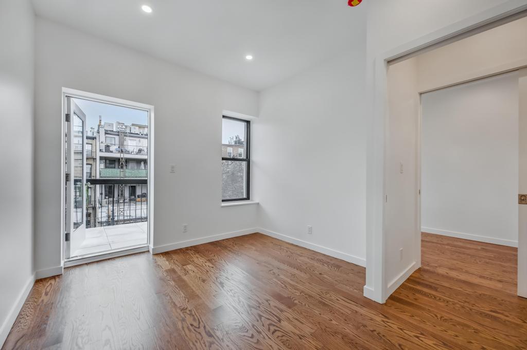 109 President Street, Unit 3 Brooklyn, NY 11231 - Photo 14 of 18 an empty room with wooden floor and windows
