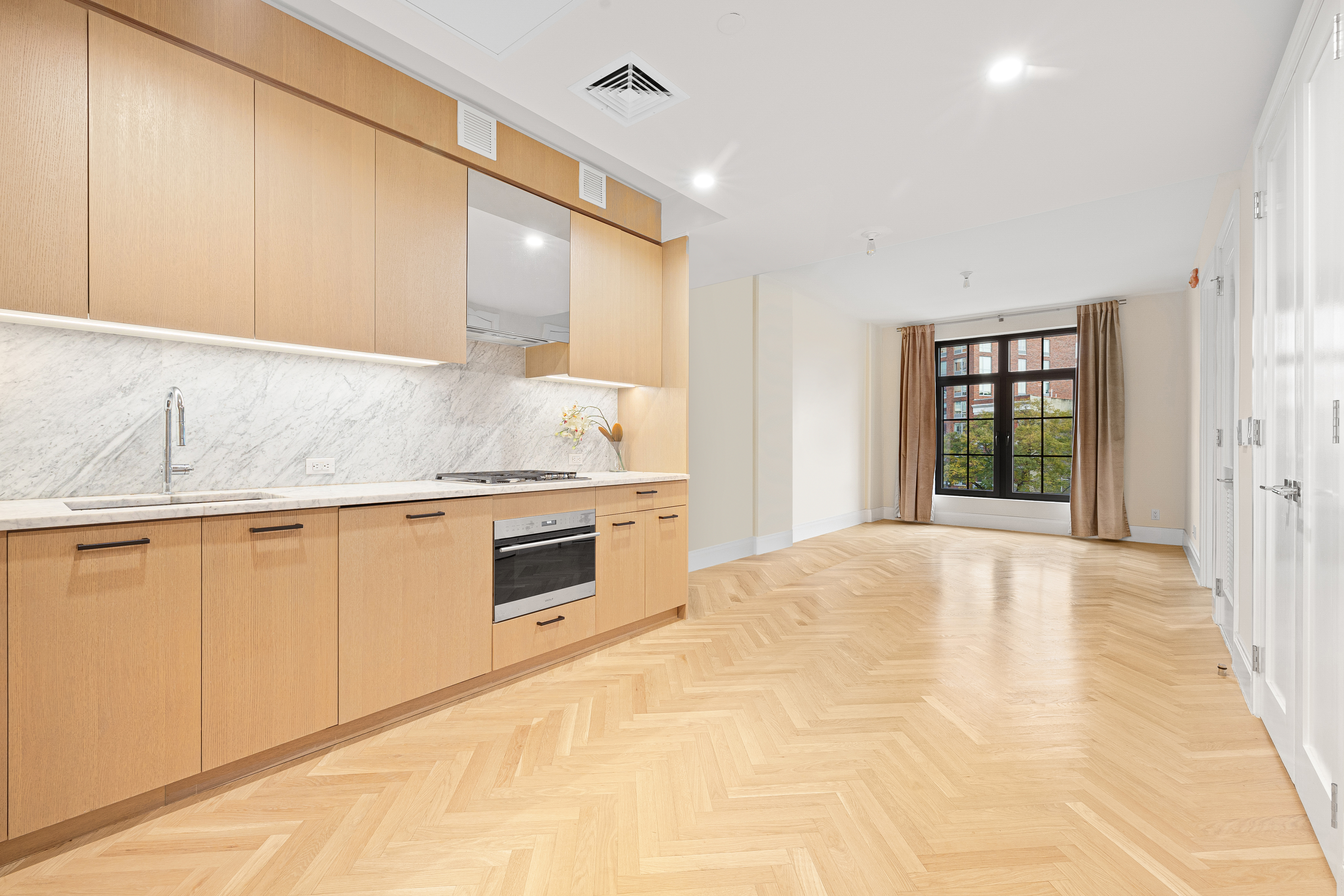300 West 122nd Street, Unit 4F Manhattan, NY 10027 - Photo 2 of 32 a kitchen with granite countertop white cabinets and white appliances