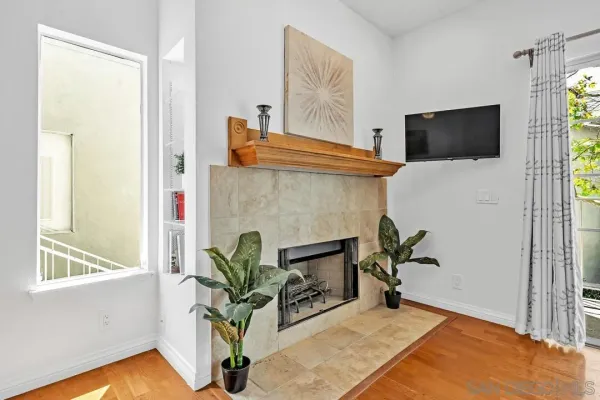 a living room with furniture a flat screen tv and a potted plant