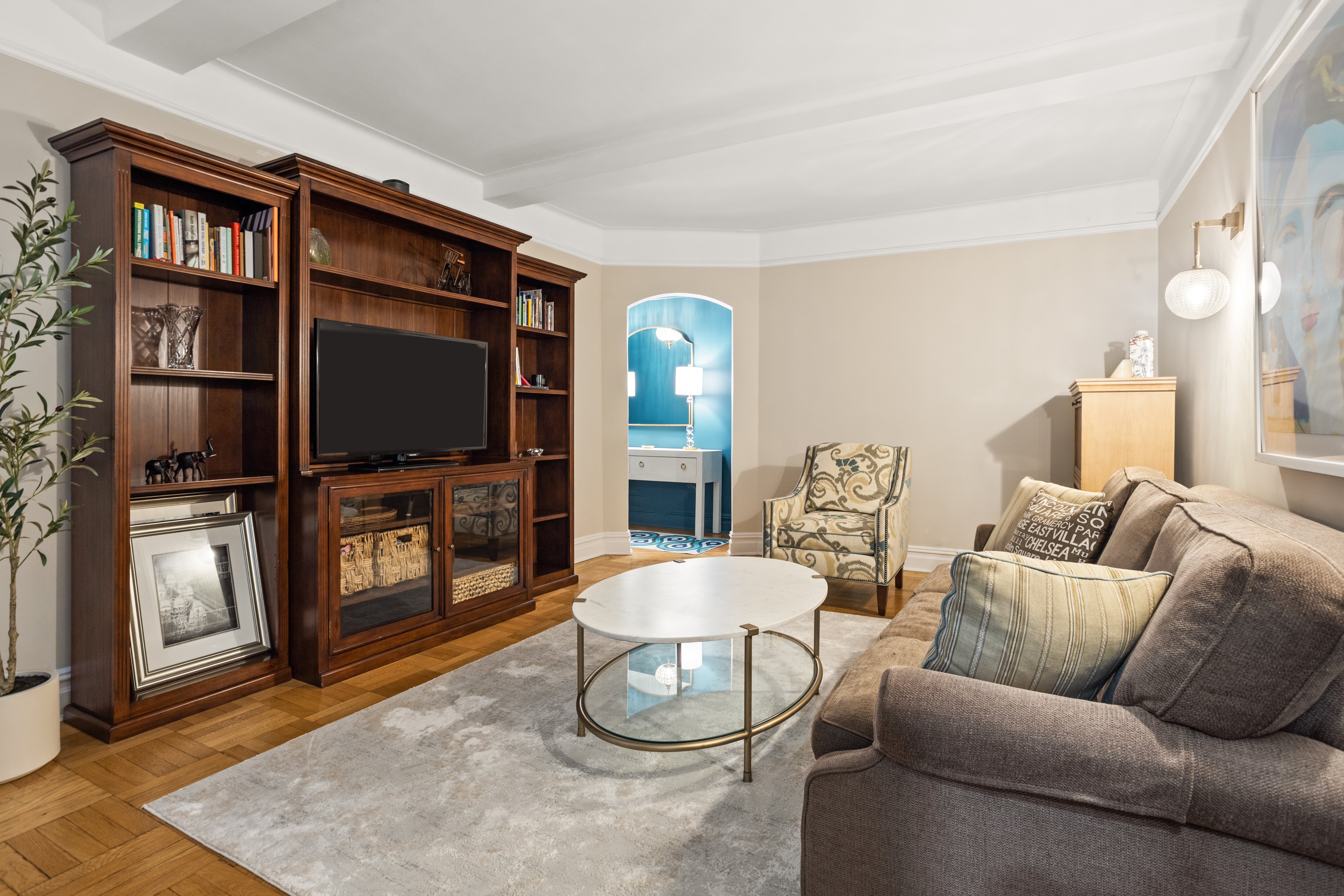 107 West 86th Street, Unit 3H Manhattan, NY 10024 - Photo 2 of 7 a living room with furniture a flat screen tv and a fireplace