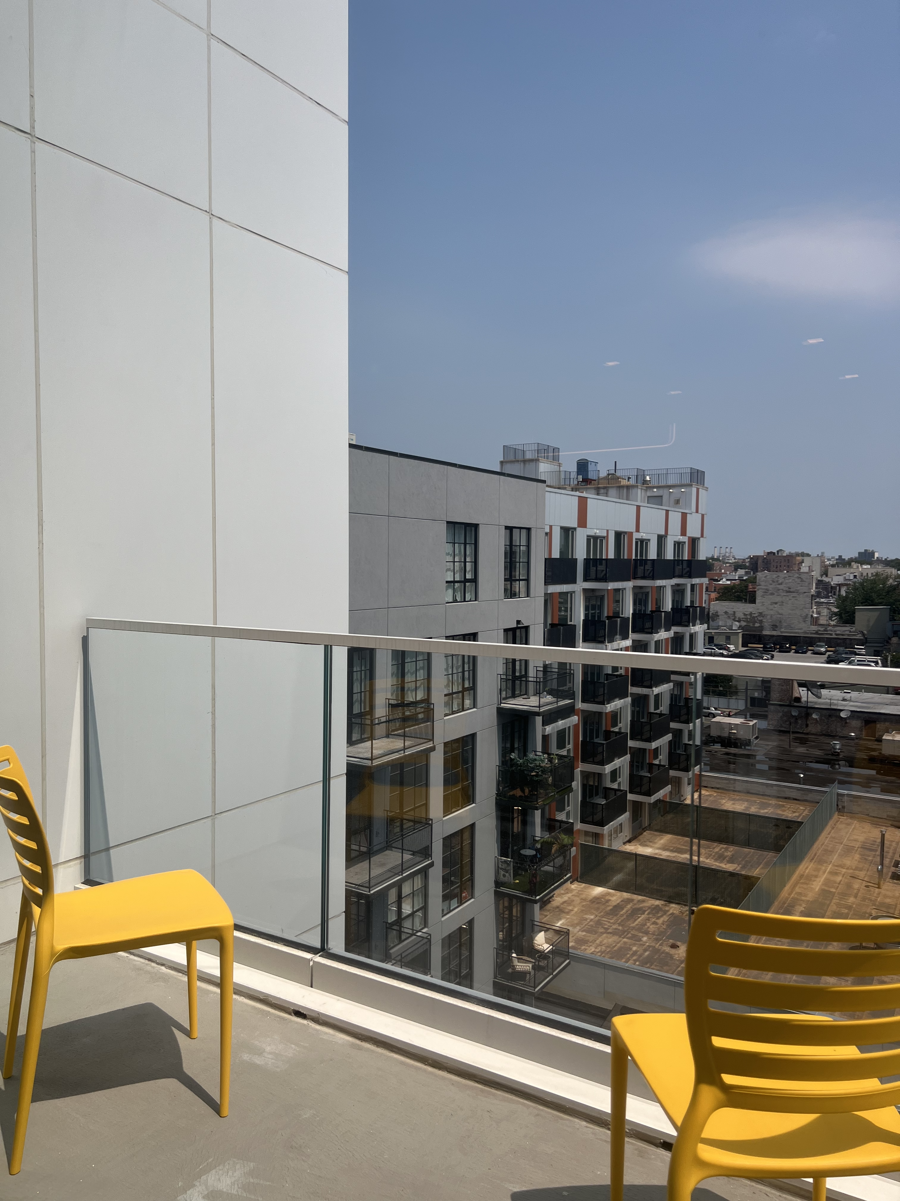 37-34 33rd Street, Unit 7H Queens, NY 11101 - Photo 8 of 18 a view of a balcony with chairs