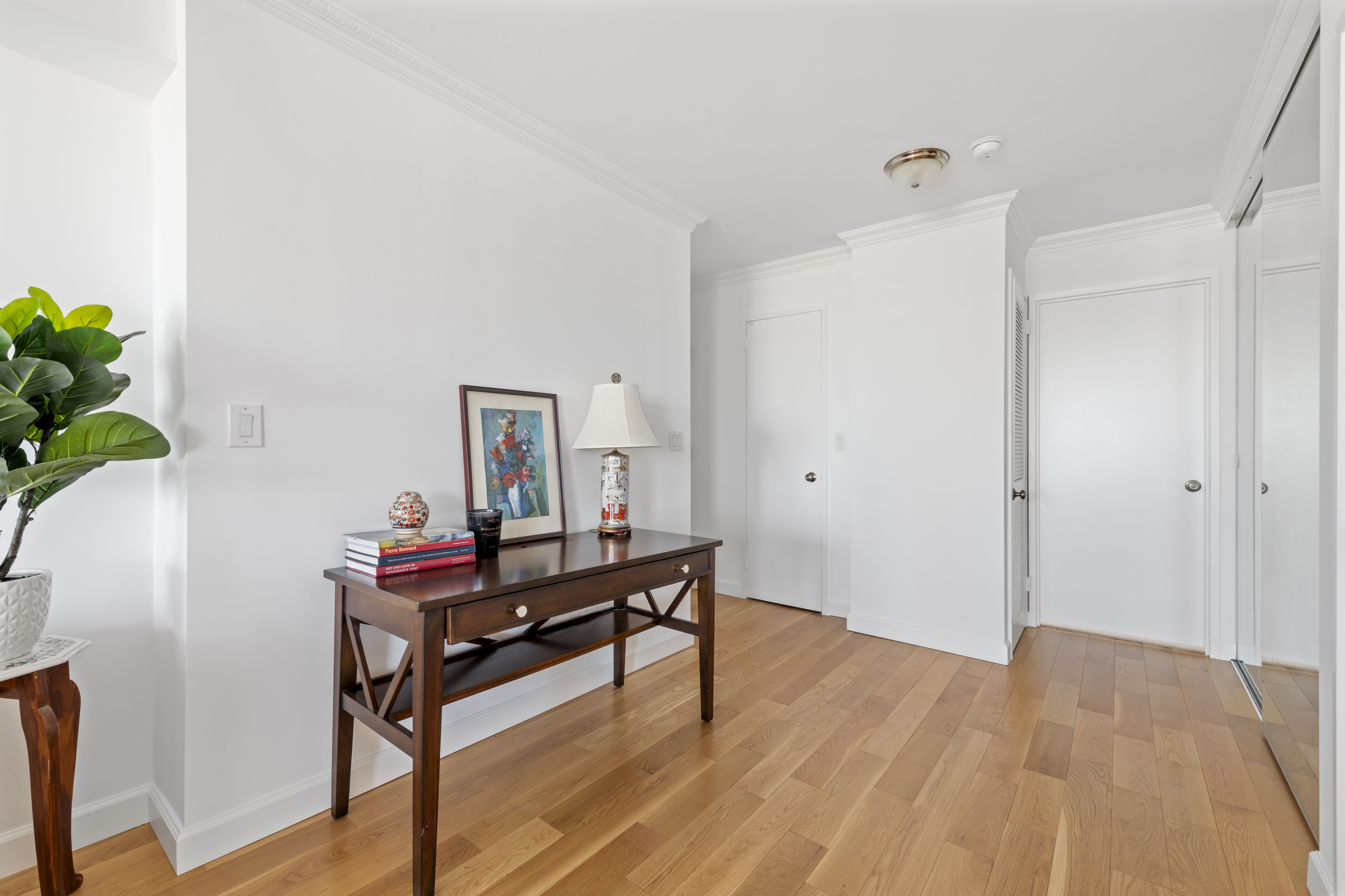 171 East 84th Street, Unit 31C Manhattan, NY 10028 - Photo 8 of 18 a view of a workspace with furniture and wooden floor