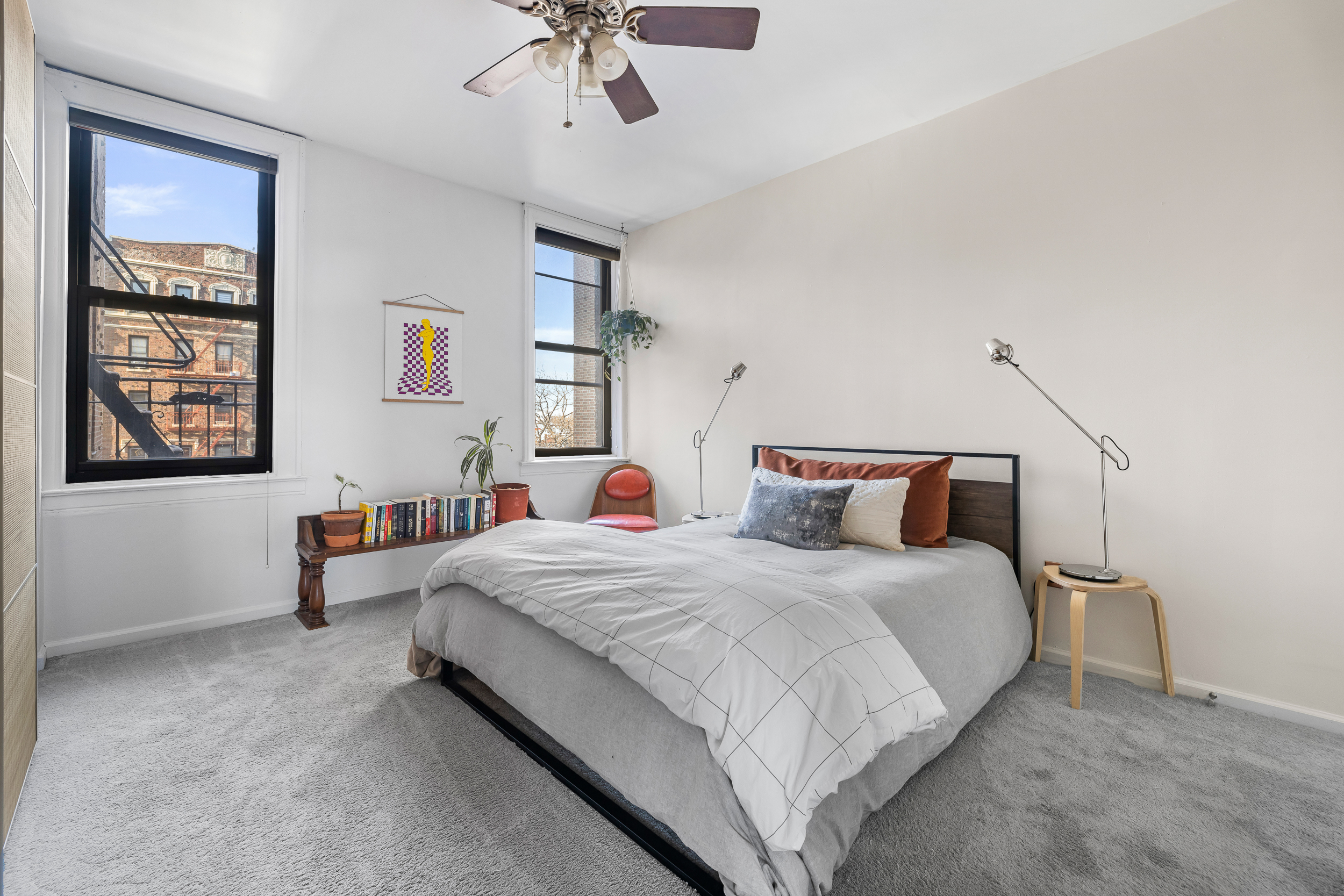 7901 4th Avenue Brooklyn, NY 11209 - Photo 8 of 10 a bedroom with a bed and a chandelier