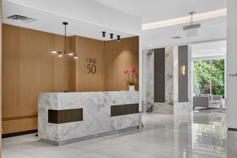 a spacious bathroom with a granite countertop sink a mirror and shower