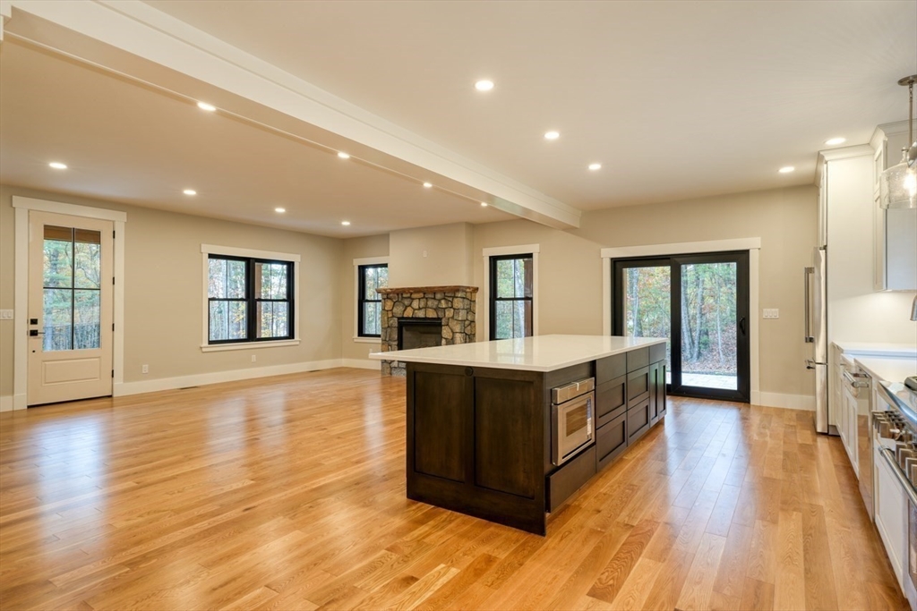 171 Randall Road Berlin, MA 01503 - Photo 6 of 41 a large kitchen with stainless steel appliances granite countertop a large counter top and a wooden floors