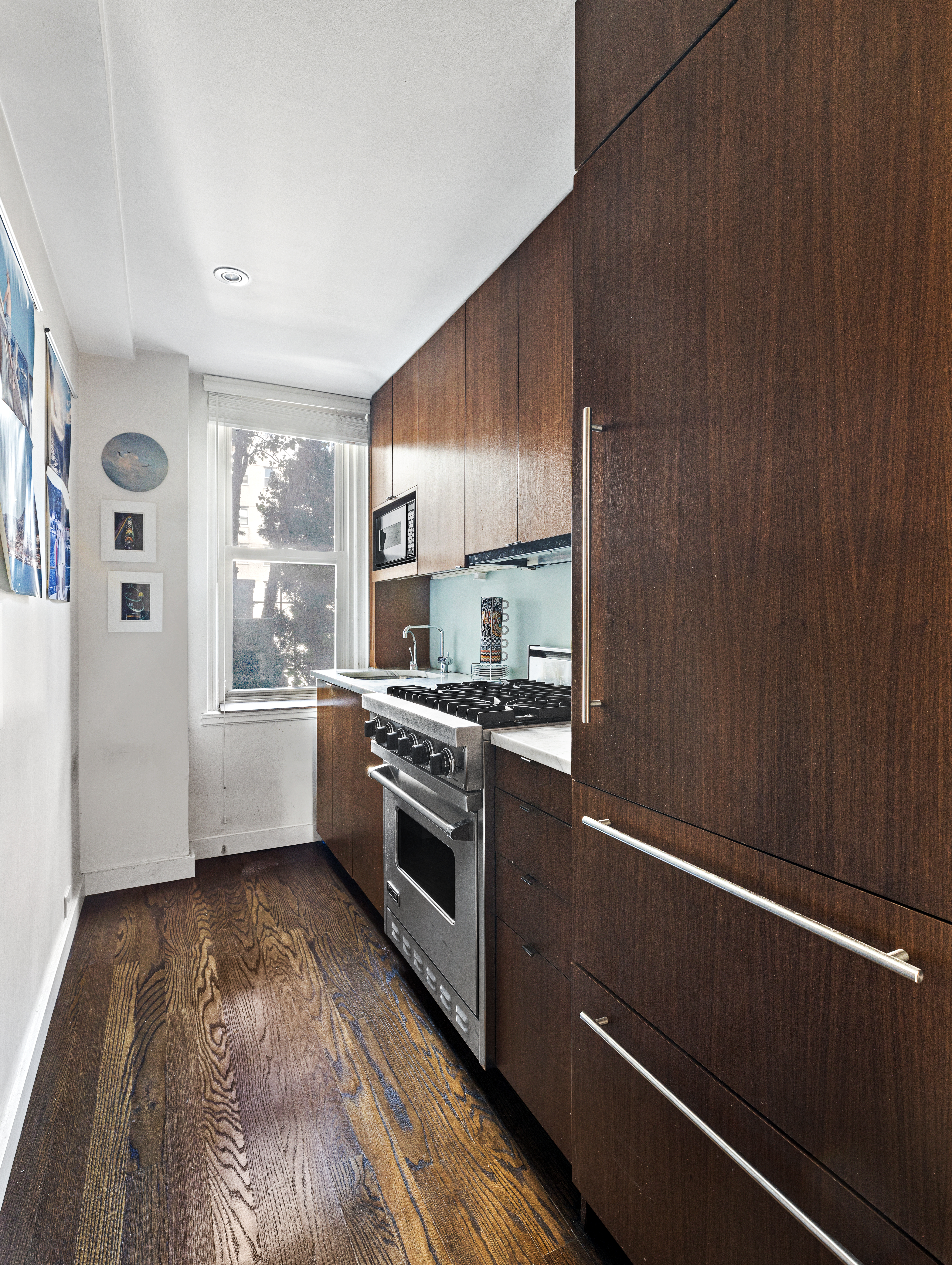59 West 12th Street, Unit 11C Manhattan, NY 10011 - Photo 4 of 10 a kitchen with a refrigerator and white cabinets