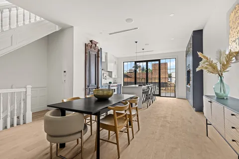 a dining room with furniture and wooden floor