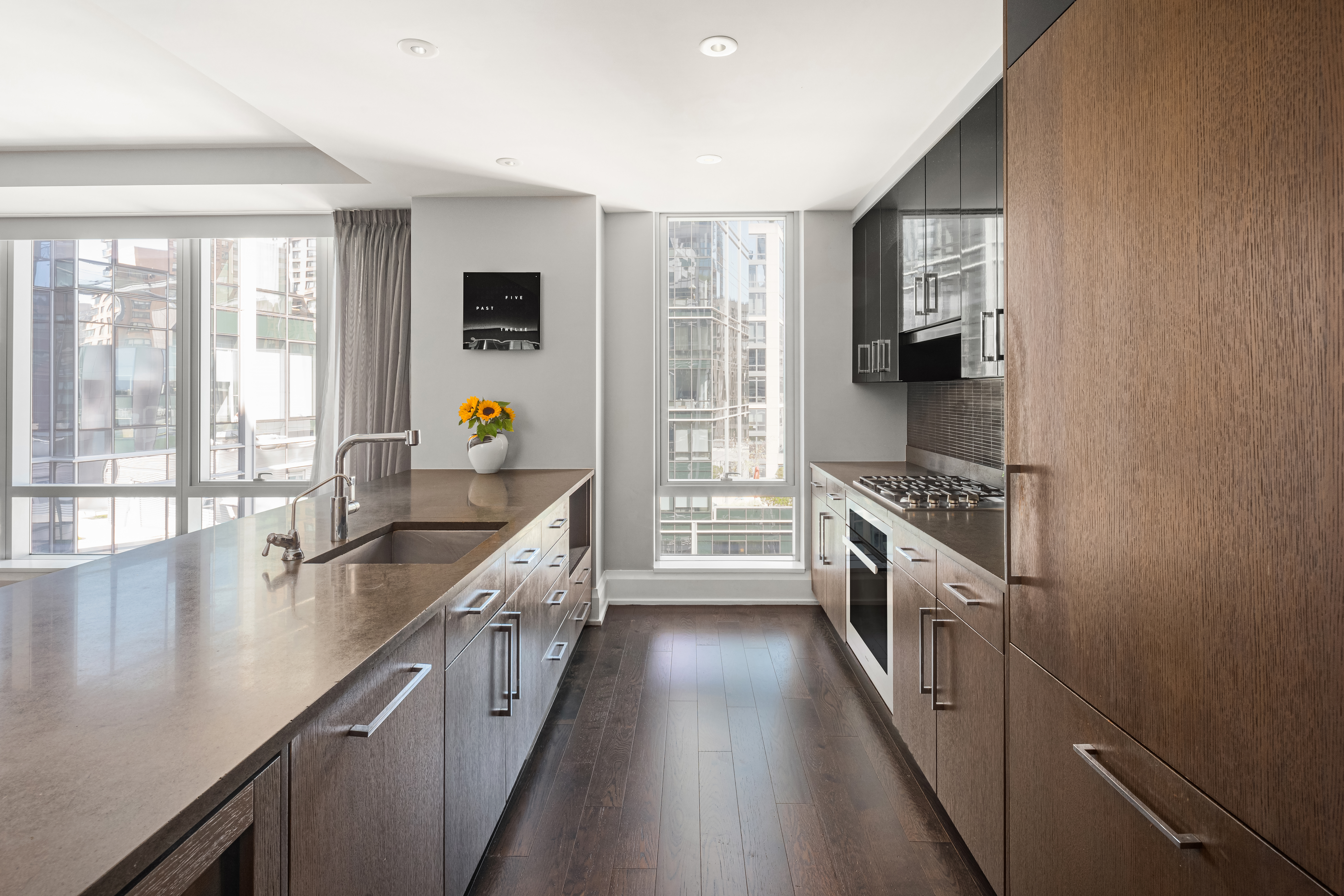 50 Riverside Boulevard, Unit 10P Manhattan, NY 10069 - Photo 6 of 21 a kitchen with stainless steel appliances a sink a stove and a window