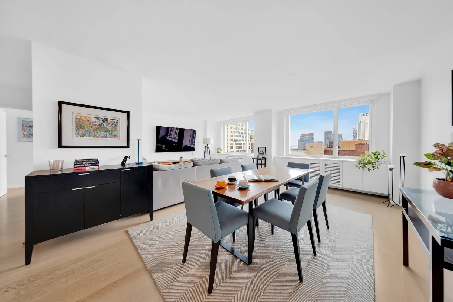 a view of a dining room with furniture and a kitchen