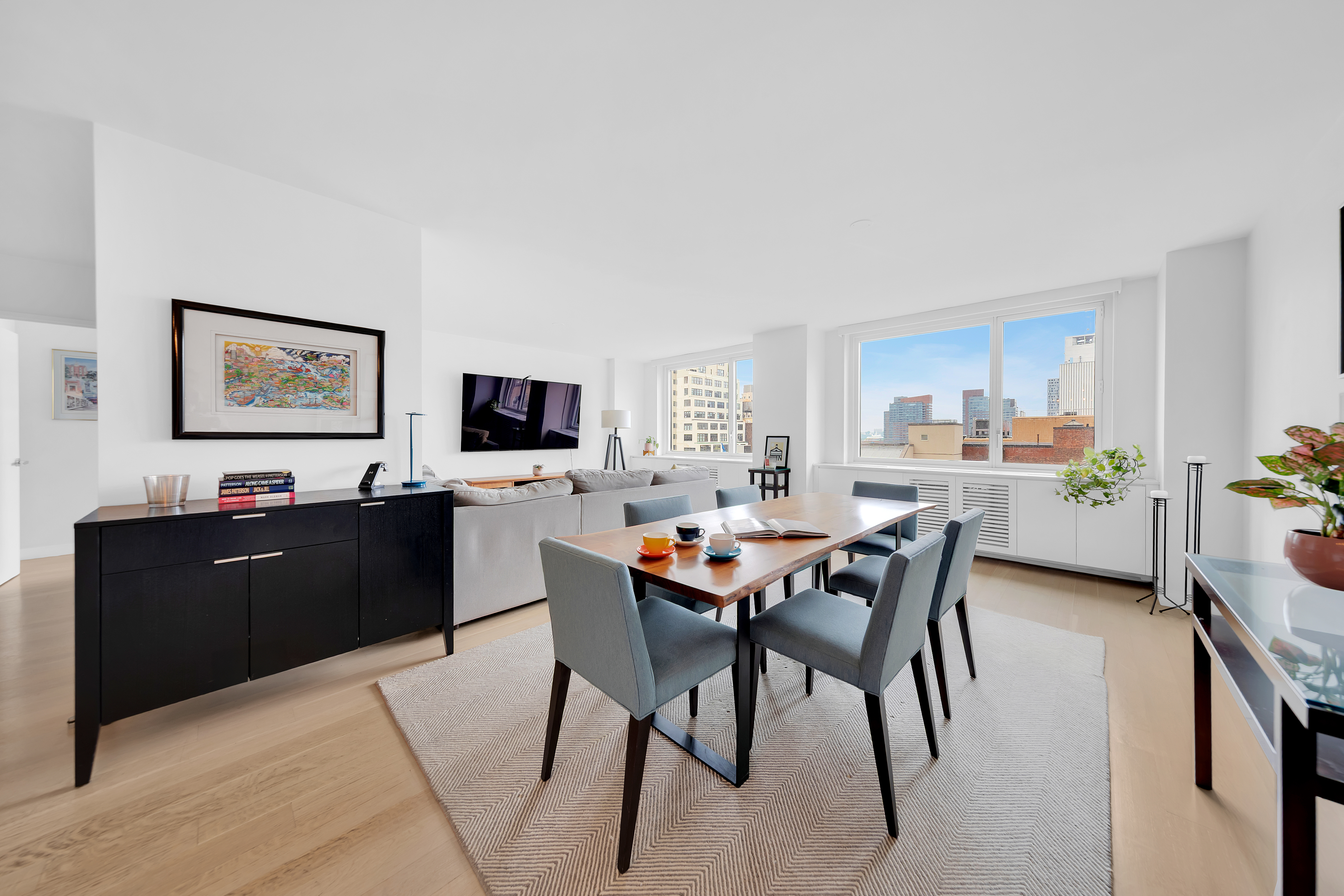 301 West 53rd Street, Unit 10C Manhattan, NY 10019 - Photo 2 of 11 a view of a dining room with furniture and a kitchen