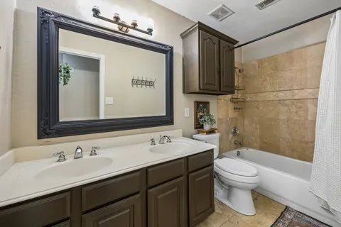 a bathroom with a sink toilet and mirror