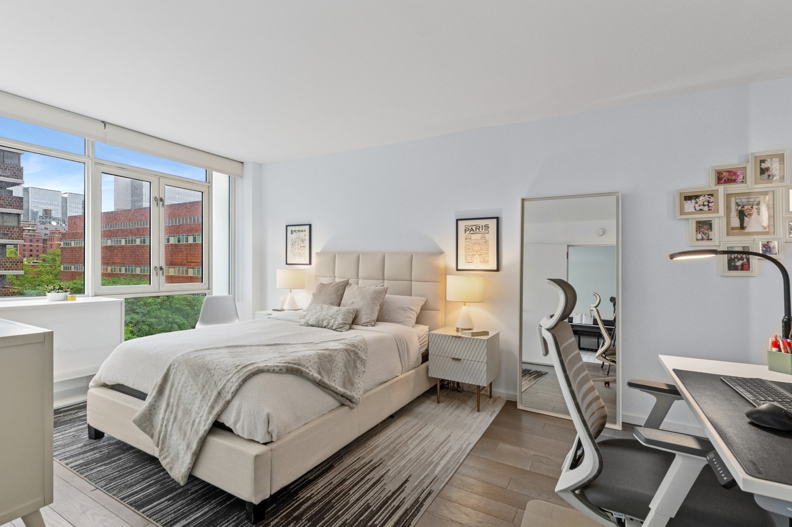 385 1st Avenue, Unit 6B Manhattan, NY 10010 - Photo 5 of 15 a bedroom with a bed a glass walk in closet and a large window