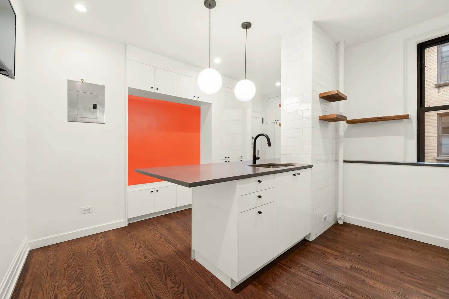 a kitchen with cabinets and wooden floor