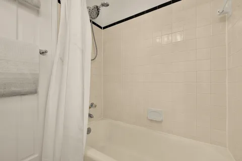 a close up of a bathtub curtain