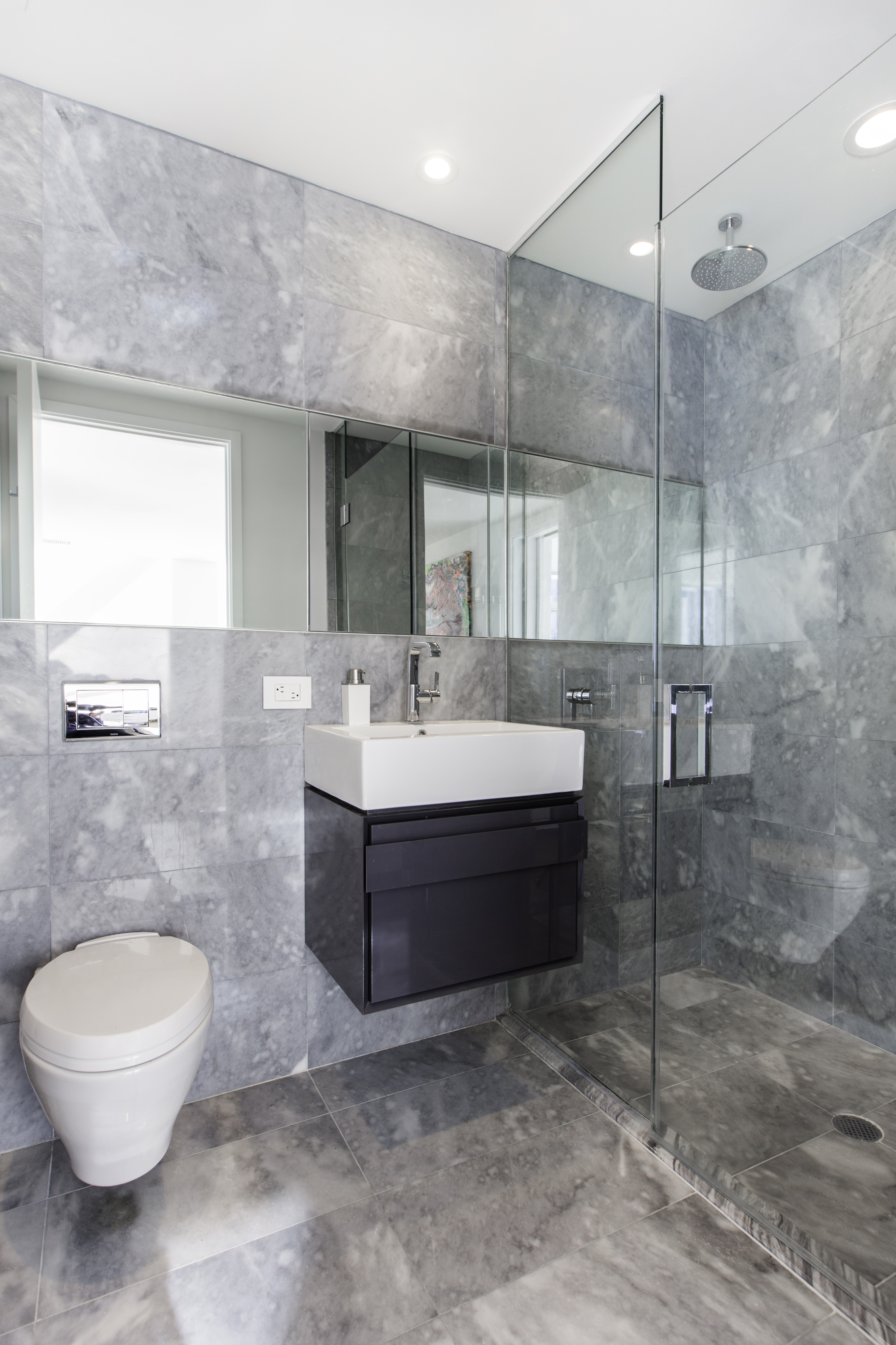 100 Norfolk Street, Unit PH Manhattan, NY 10002 - Photo 20 of 23 a bathroom with a sink a toilet and a mirror