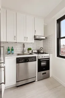 a bedroom with furniture and a large window