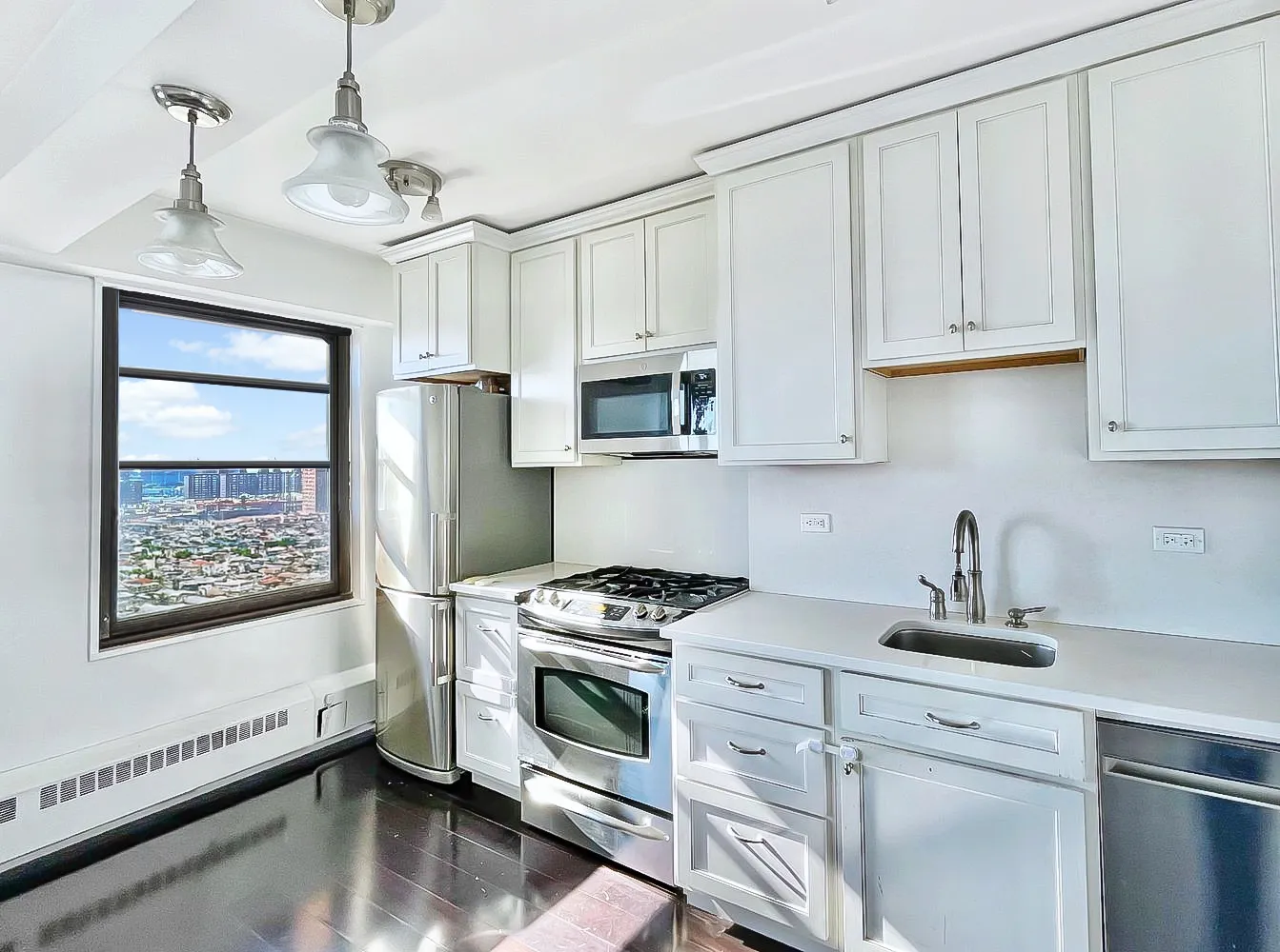 a kitchen with granite countertop white cabinets and white appliances