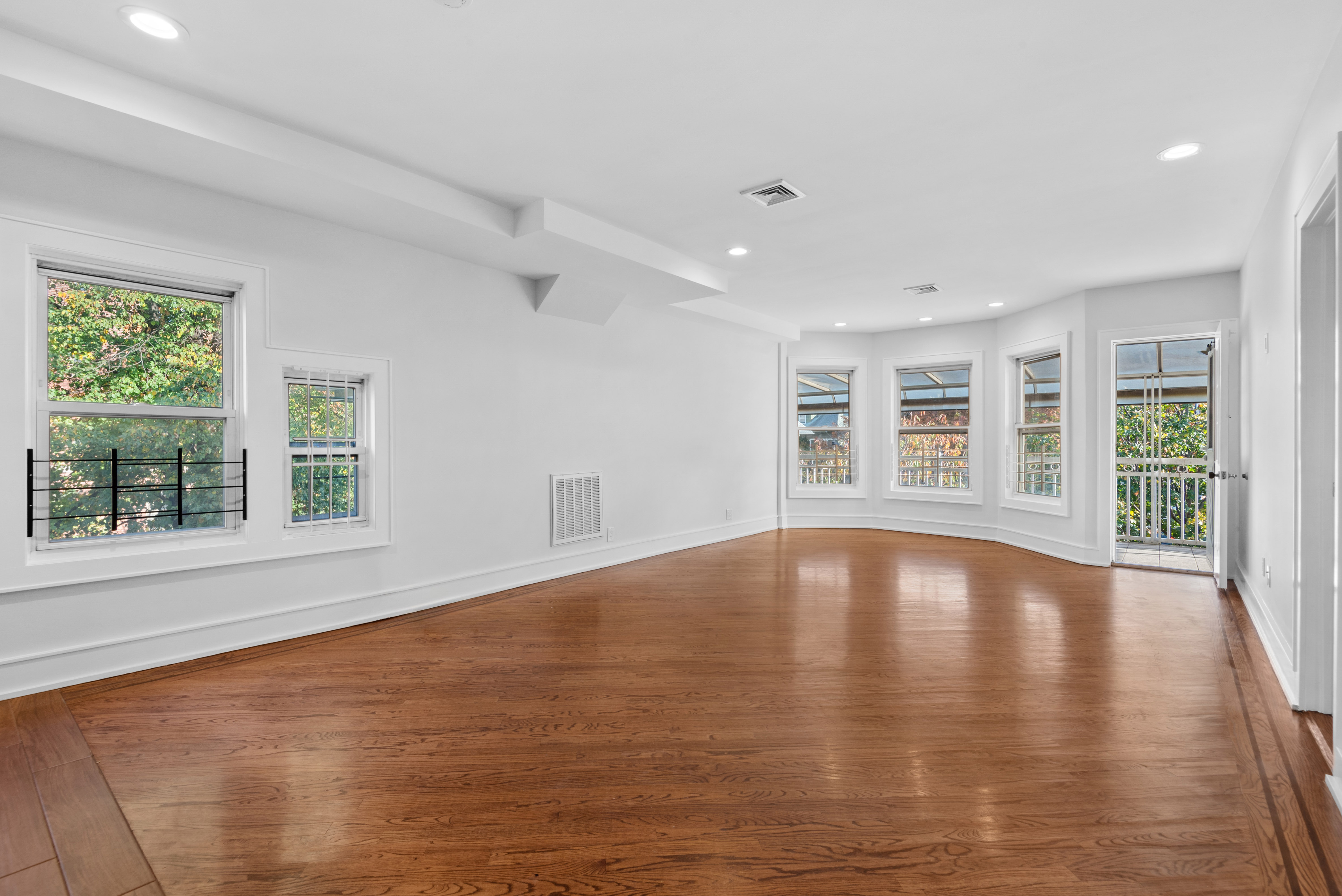 1617 Dorchester Road, Unit 2 Brooklyn, NY 11226 - Photo 2 of 6 a view of an empty room with wooden floor and a window