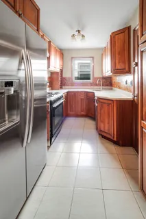 a kitchen with stainless steel appliances granite countertop a refrigerator and a stove top oven