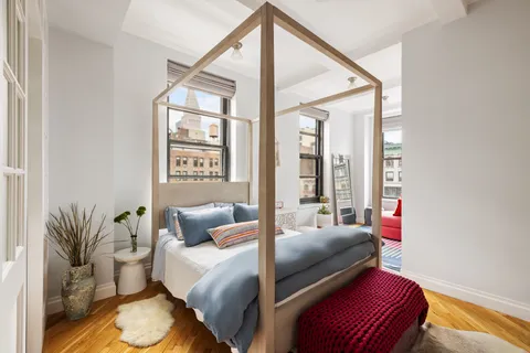 a bedroom with furniture and wooden floor