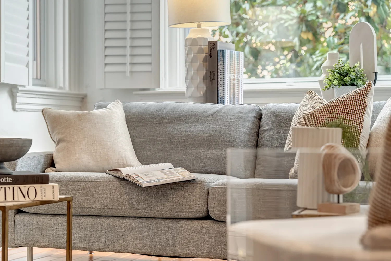 a bedroom with a bed and a potted plant on the table