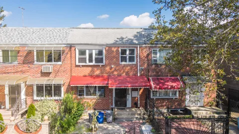 an aerial view of residential houses with outdoor space and street view