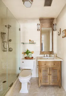 a bathroom with a granite countertop toilet sink and shower