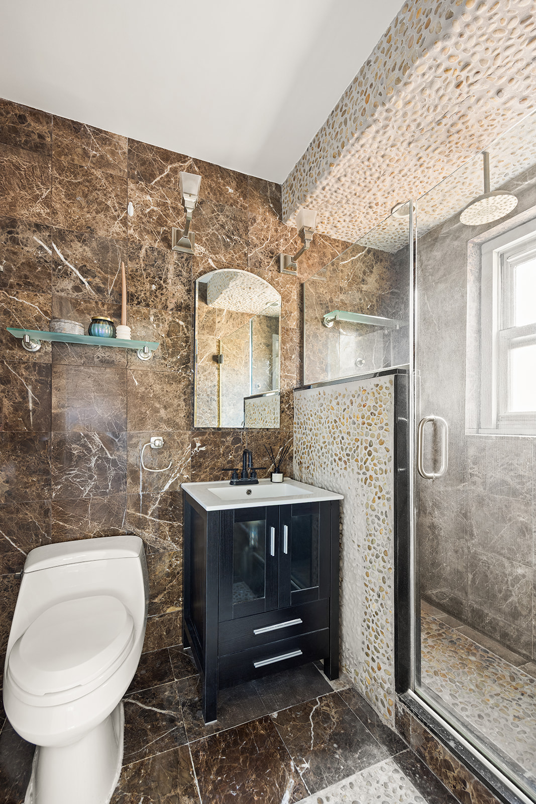 159 West 53rd Street, Unit 27H Manhattan, NY 10019 - Photo 8 of 15 a bathroom with a toilet sink and mirror