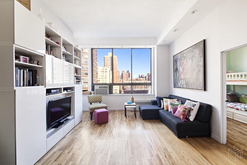 310 East 23rd Street, Unit 11FG Manhattan, NY 10010 - Photo 1 of 9 a living room with furniture and a fireplace