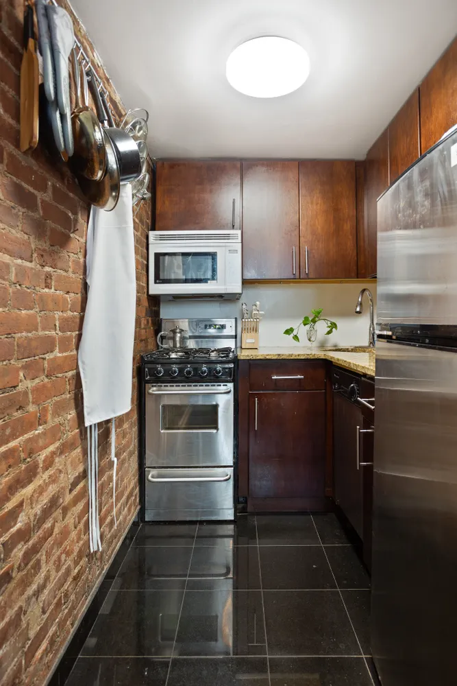 55 West 84th Street, Unit 5 Manhattan, NY 10024 - Photo 3 of 8 a kitchen with a stove and a microwave