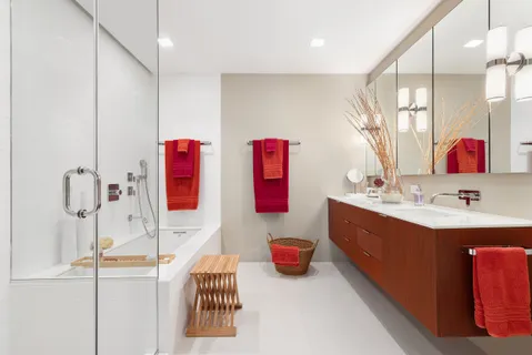 a bathroom with a tub sink and mirror