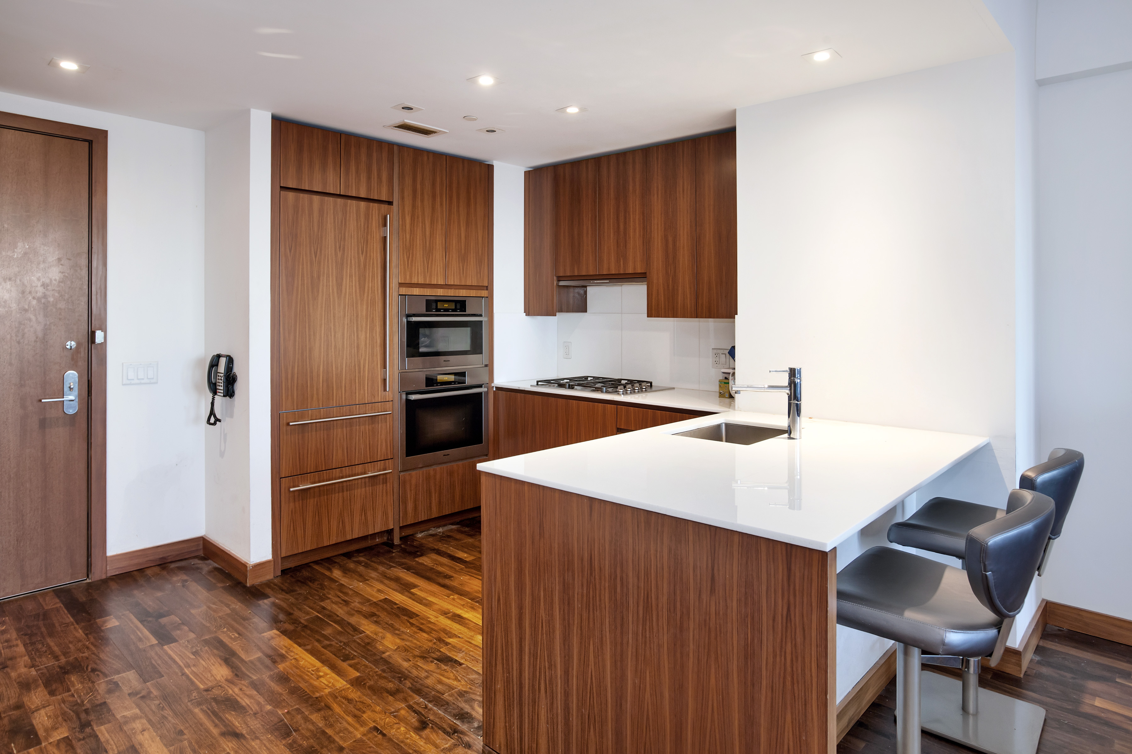 400 5th Avenue, Unit 35C Manhattan, NY 10018 - Photo 3 of 13 a kitchen with kitchen island a sink stove and refrigerator