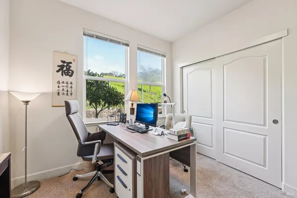 a bedroom with bed and a large window