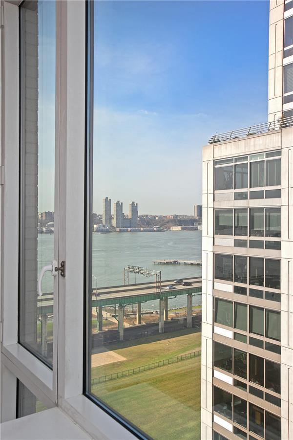100 Riverside Boulevard, Unit 14D Manhattan, NY 10069 - Photo 12 of 13 a view of a balcony with a floor to ceiling window and wooden floor