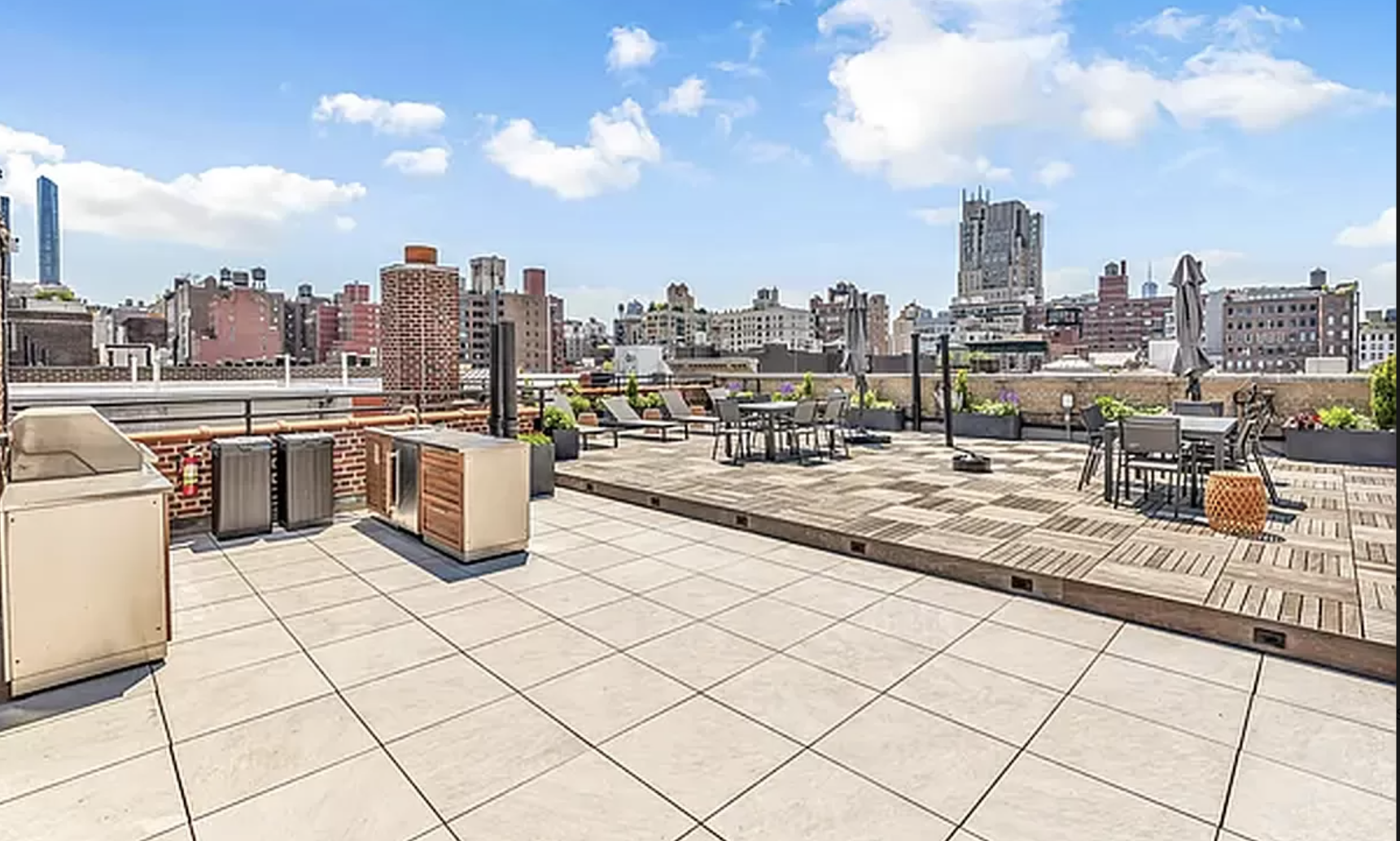 261 West 22nd Street, Unit 4 Manhattan, NY 10011 - Photo 7 of 8 a outdoor kitchen with stainless steel appliances granite countertop a sink and a stove